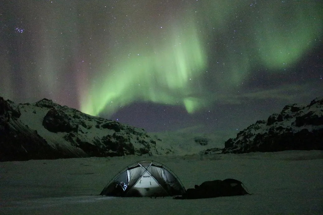 The aurora borealis shining over our tent