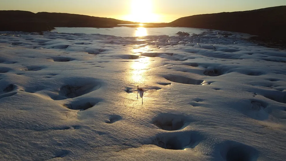 Drone shot of the glacier. Flat ice with large holes in it