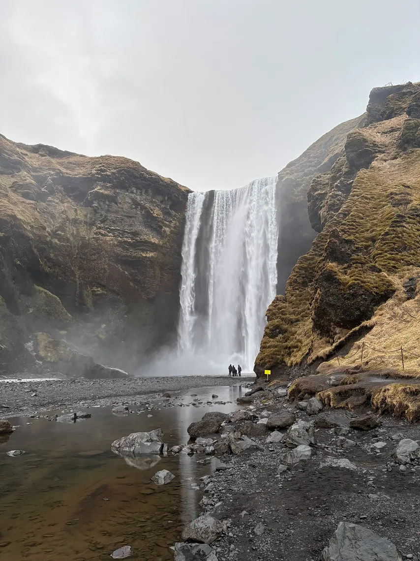 A huge waterfall tumbles down a cliff
